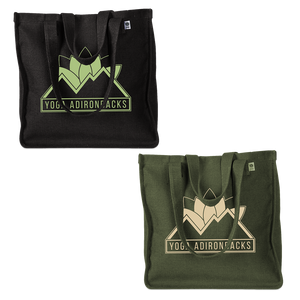 Yoga Adirondacks' lotus mountain logo, printed on the side of a sturdy woven hemp tote bag. Available in Black and Olive.