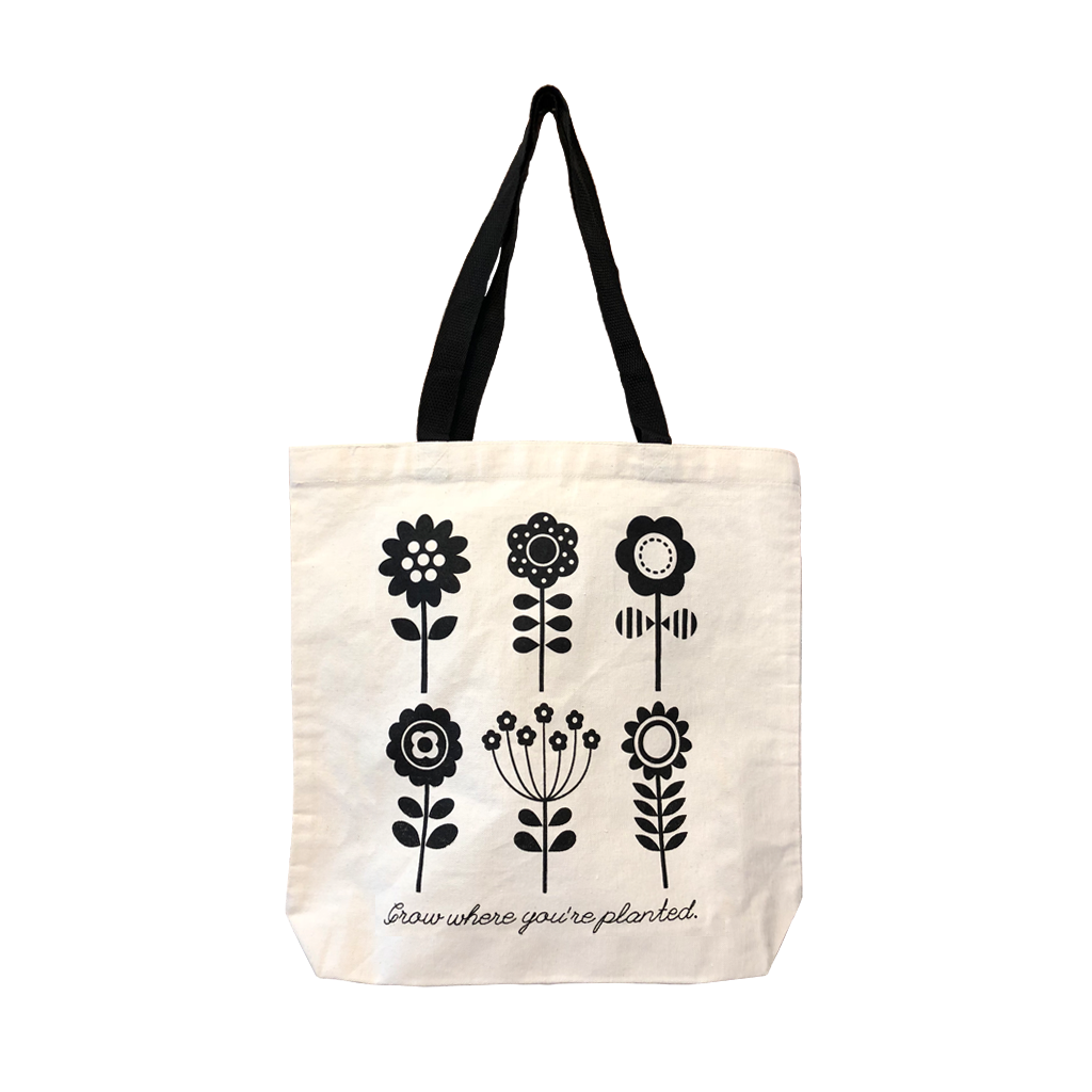 "Grow Where You're Planted" tote bag, featuring a custom design of stylized flowers in black on a natural canvas bag.  Only Found at 518 Prints