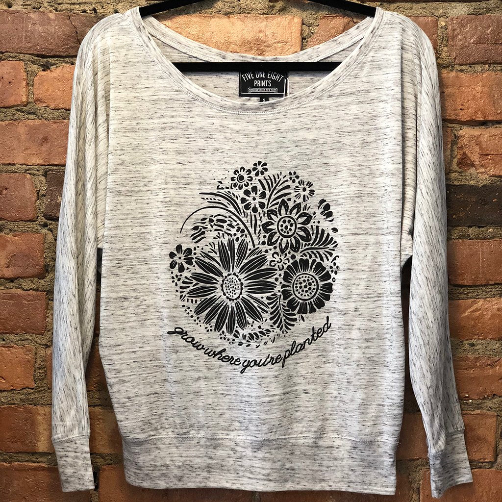 Grow where you're planted - and show off your resilient spirit in our comfortable flowy long sleeve. Custom design, printed in black on the front of a white marble colored shirt.  Only found at 518 Prints