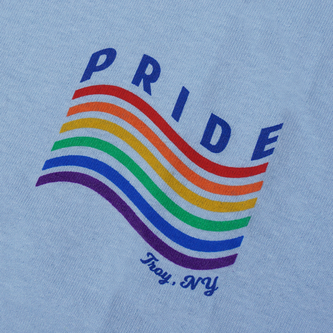 Love is love is love. Our 2019 Pride Month tee features a minimalist rainbow with the words "Pride" and "Troy NY" on the front left chest of a light blue tee. Only found at 518 Prints