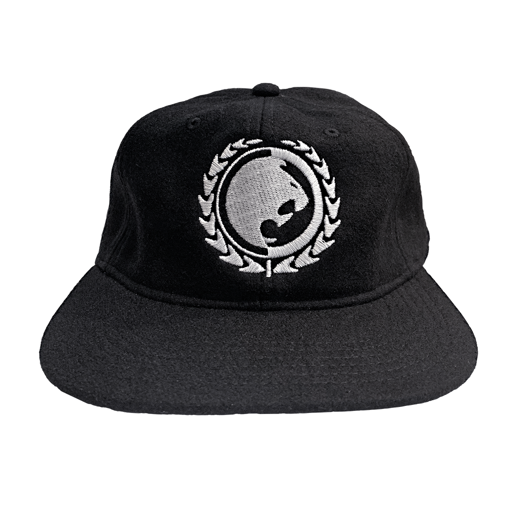 Renzo Gracie Latham's lion head design, embroidered on the front of a black AS Colour hat.  Cap features: lower profile, unstructured six-panel; adjustable fastener with metal clasp and tonal under-peak lining; mid-weight; flat peak; 50% wool/50% polyester fabric. One size fits all.