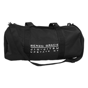 Renzo Gracie Latham's "Upstate Stack Logo" design, printed on the side of a black Independent brand duffel bag.  Bag features include 100% polyester fabric, waterproof interior PVC coating, zipped mesh pocket (5.5” height, 8.25” width) on inside, carrying handles, and removable shoulder strap. Bag measures 20.5” x 10.5”.