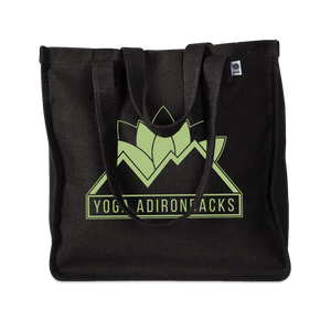 Yoga Adirondacks' lotus mountain logo, printed on the side of a sturdy woven hemp tote bag. Available in Black and Olive.