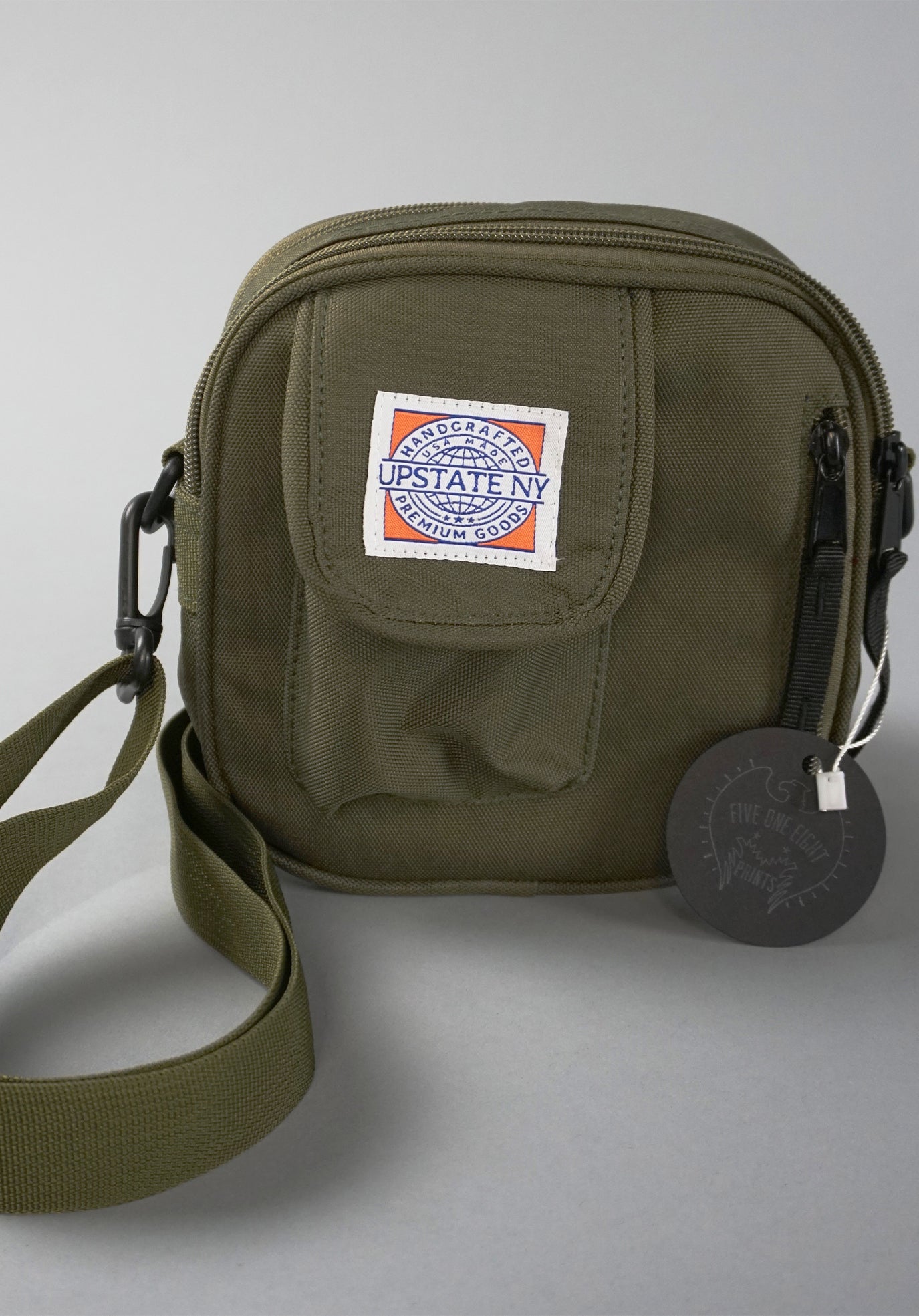Essentials bag in olive green, showing detail of bag structure and custom Upstate NY sewn-on patch.