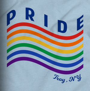 Love is love is love. Our 2019 Pride Month tee features a minimalist rainbow with the words "Pride" and "Troy NY" on the front left chest of a light blue tee.  Only found at 518 Prints