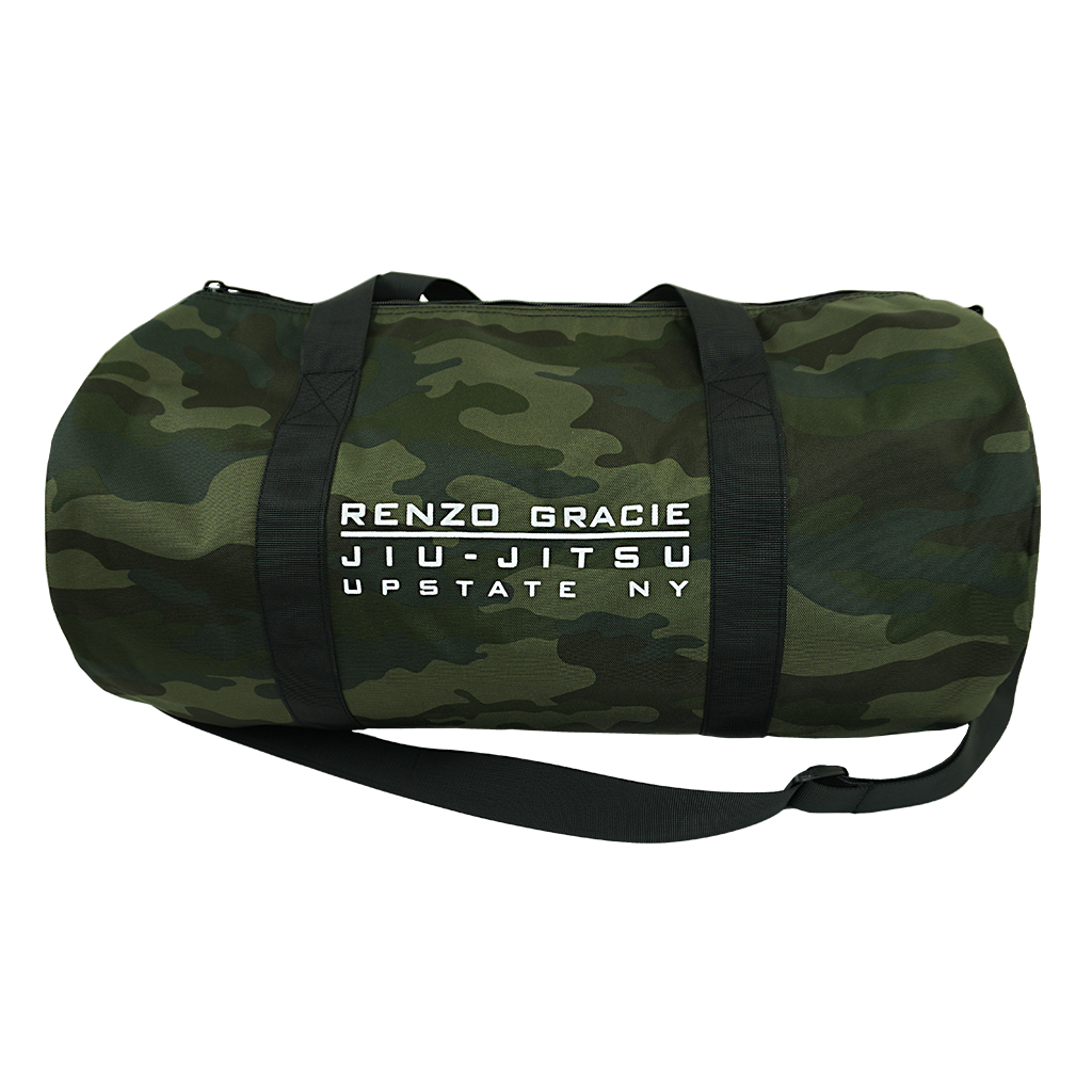 Renzo Gracie Latham's "Upstate Stack Logo" design, printed on the side of a forest camo Independent brand duffel bag.  Bag features include 100% polyester fabric, waterproof interior PVC coating, zipped mesh pocket (5.5” height, 8.25” width) on inside, carrying handles, and removable shoulder strap. Bag measures 20.5” x 10.5”.