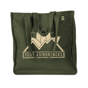 Yoga Adirondacks' lotus mountain logo, printed on the side of a sturdy woven hemp tote bag. Available in Black and Olive.