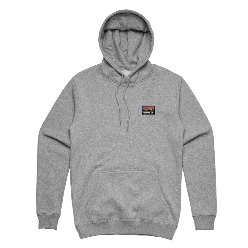 A big statement on a small patch! Our custom-woven Upstate NY patch features a stylized sunrise over a forest skyline. The patch is sewn to the front left chest of an athletic heather pullover hooded sweatshirt.  Only found at 518 Prints
